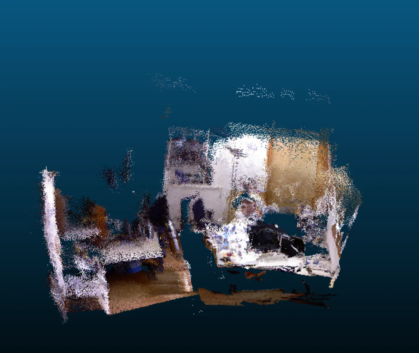 A coloured 3-D point cloud of an office desk with two monitors, a keyboard and a chair, reconstructed from RGB-D frames placed along the EKF-SLAM trajectory, seen from above and slightly to one side.