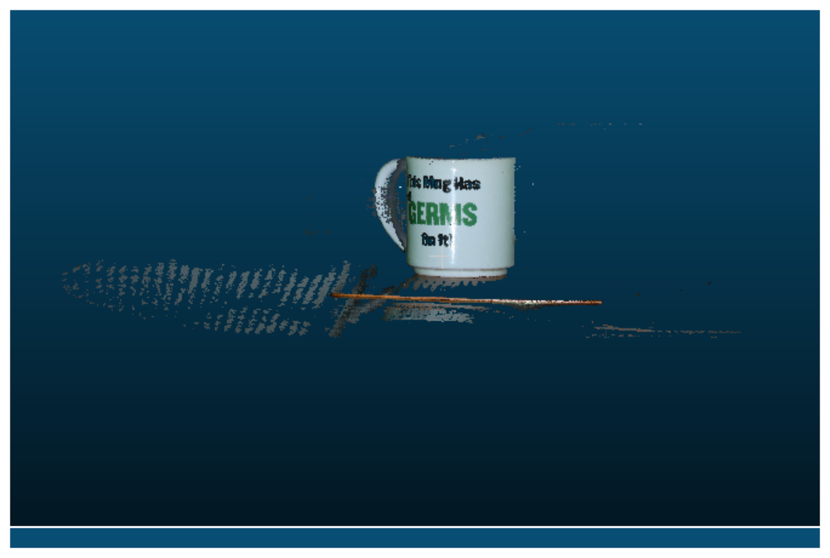 Point cloud of the Cup scene from the projector-camera setup, in profile, showing the mug, a stray ruler, and specular noise on the reflective table